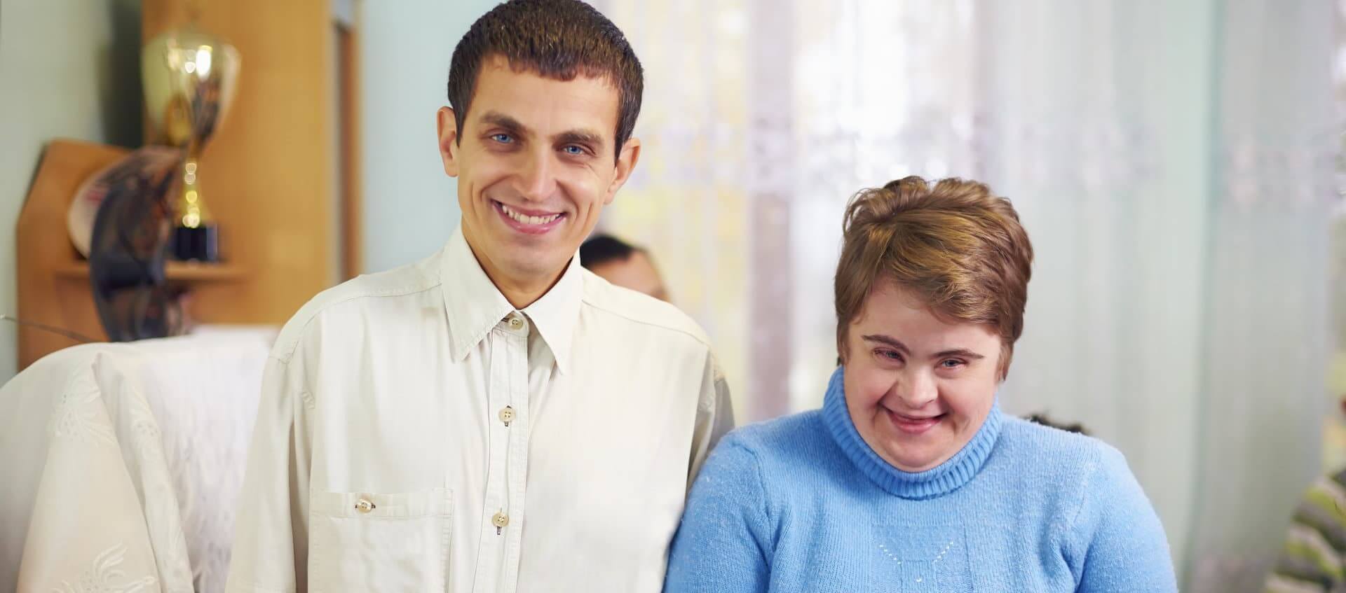 adult man and woman smiling
